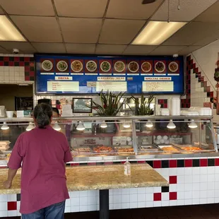 a man and a woman standing in front of a counter