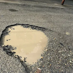 huge pot hole in parking lot