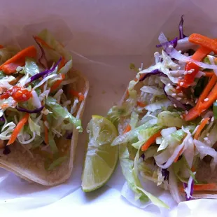 two tacos with slaw, carrots, and cabbage