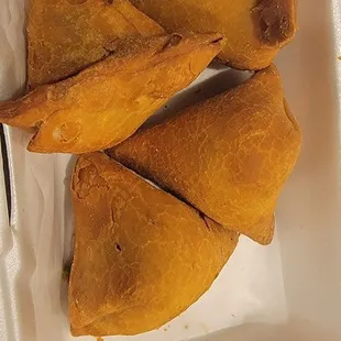 a white styrofoam container filled with fried food