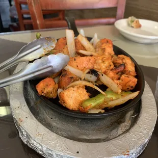 Chicken Tikka sizzling at our table yummmmm