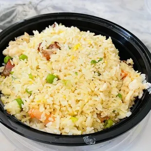 a bowl of fried rice with vegetables