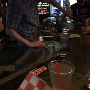 a man pouring a drink at a bar