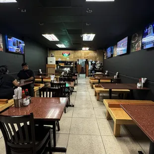 Inside table with tons of TVs on the wall