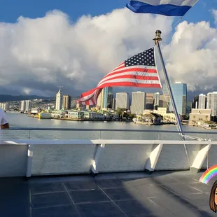a man standing on a boat with an american flag