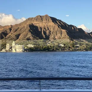 a sailboat in the water with mountains in the background