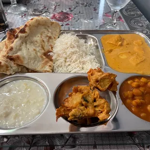 a silver tray with a variety of food items