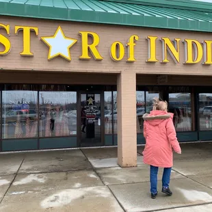 a woman standing in front of a store