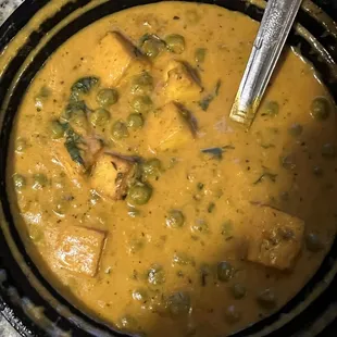 a bowl of soup with a spoon in it