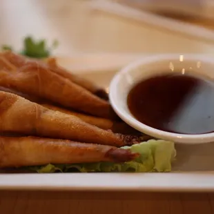 a plate of food with dipping sauce