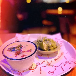 a bowl of soup and a bowl of guacamole