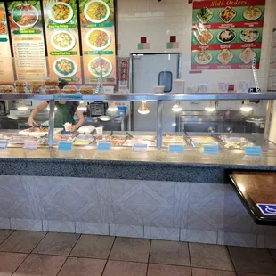 a man working behind the counter of a restaurant