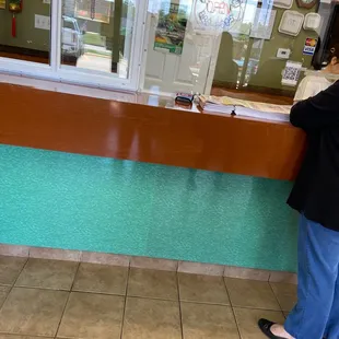 a woman standing in front of a counter