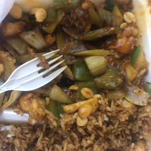 rice and vegetables in a container with a fork