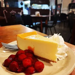 a slice of cheesecake and strawberries