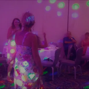 Violet washlights flood the room as the dancing continues!