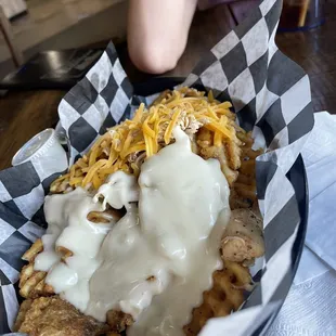 Loaded Waffle Fries with Shredded chicken. We got half shredded cheese half queso, highly recommend getting the queso!