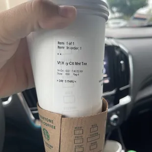 a hand holding a cup of coffee