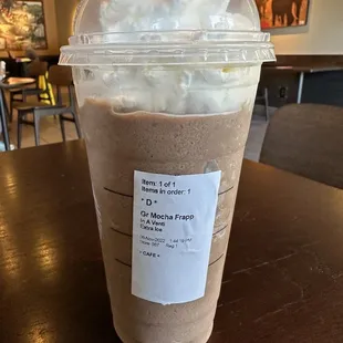 a cup of coffee with whipped cream on top