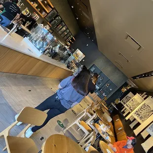 a woman standing in a coffee shop