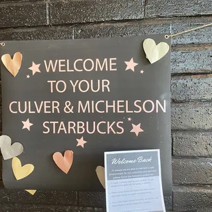 a welcome sign on a brick wall