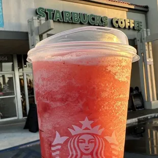 a starbucks cup with a drink in it