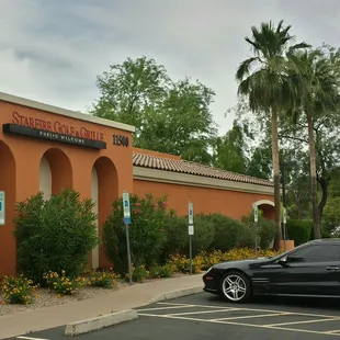 a car parked in front of a restaurant