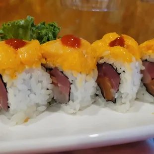 Finding Nemo roll, hamachi,salmon,tuna inside with Scallop/masago combination top