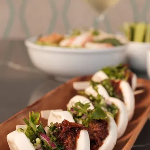 a plate of steamed buns
