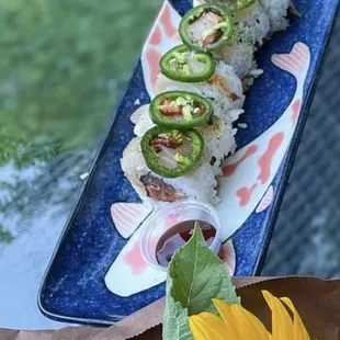 a sunflower and a plate of sushi