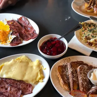 French Toast with strawberry topping, turkey bacon and cheese eggs.
