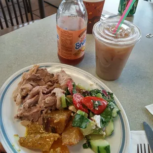 Roasted pork and roasted potatoes with Greek salad