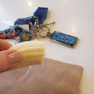 a hand holding a banana