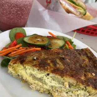Artichoke chx quiche, side salad, triple berry smoothie, ham and cheese croissant/chips in background