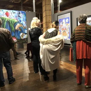 people looking at artwork