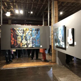 people looking at artwork