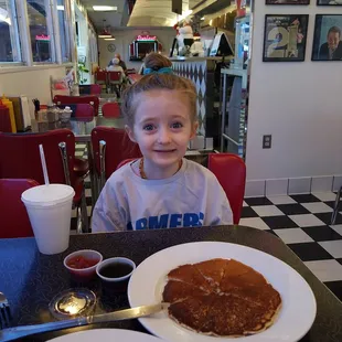 Starliner single pancake with a milk. Happy girl.