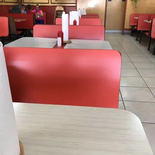 red booths and tables in a restaurant