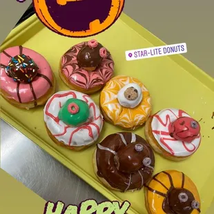 a tray of halloween doughnuts