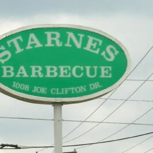 a green sign for a restaurant