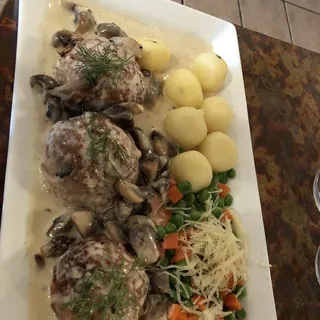 Meatballs in creamy mushroom sauce with steamed vegetables