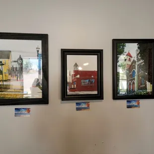 three framed photographs of a clock tower