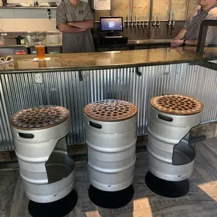 Unique bar stools, and I liked the bolts they used as taps, with the beer names written on a salvaged two piece door with windows!