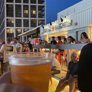 a person holding a glass of beer