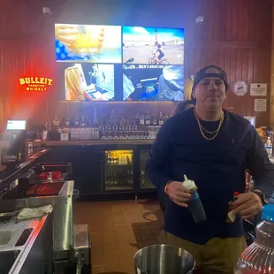 Getting served a drink by a very cool proprietor.