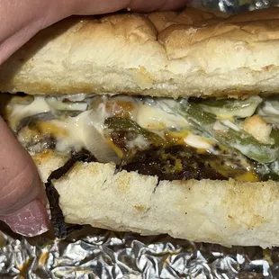 a hand holding a sandwich