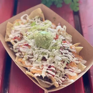 a plate of nachos on a red table