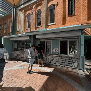 people walking in front of a store