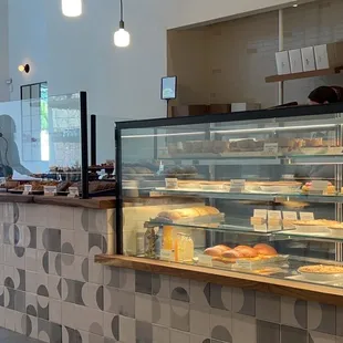 a bakery counter with a variety of pastries