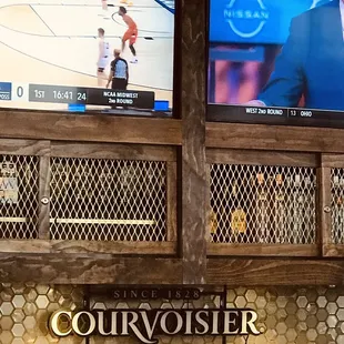 two television screens showing a basketball game